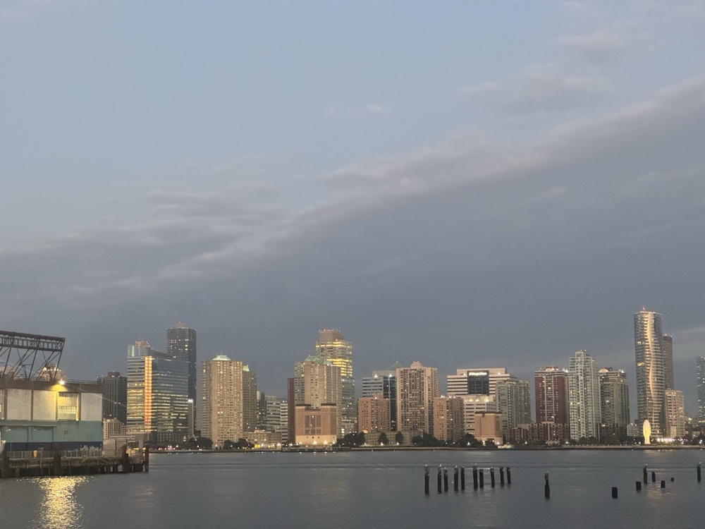 First light on the skyline across the water — the day the argument becomes something you do